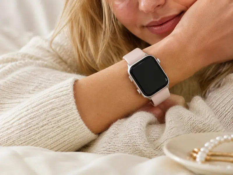 Model A wearing a pale pink silicone Apple Watch band designed for gentle everyday comfort