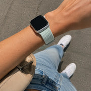 On-wrist close-up of the Céleste mint braided loop Apple Watch band
