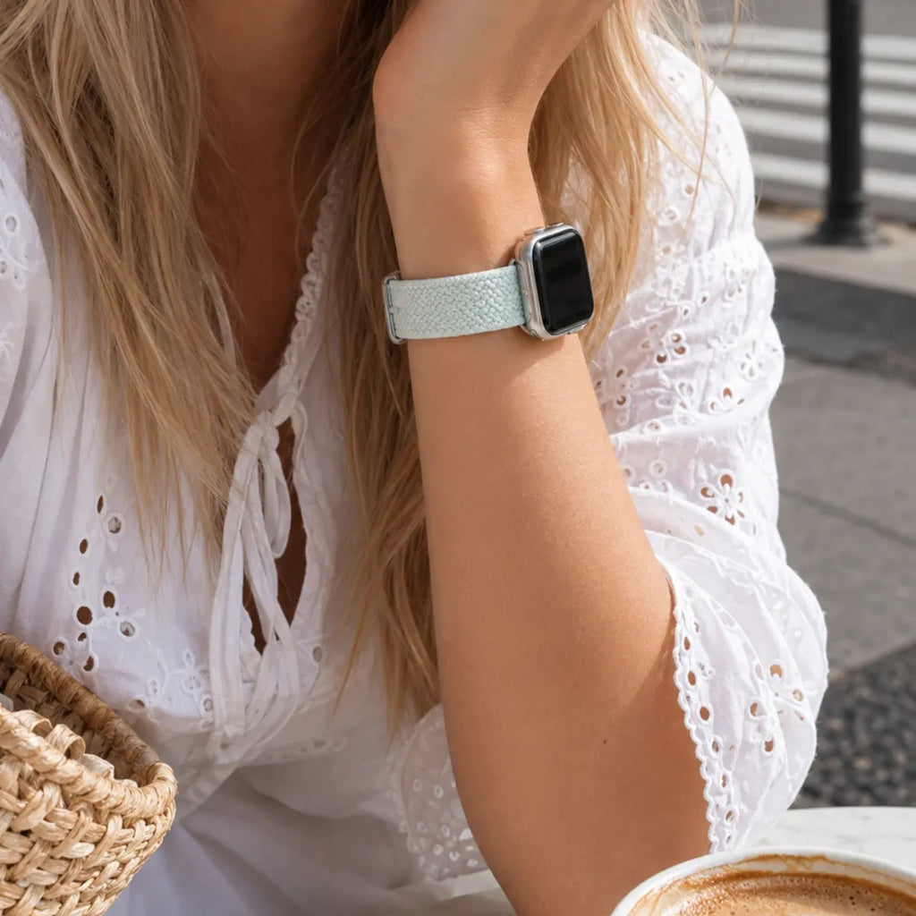 Céleste mint braided loop Apple Watch band worn with a white lace outfit
