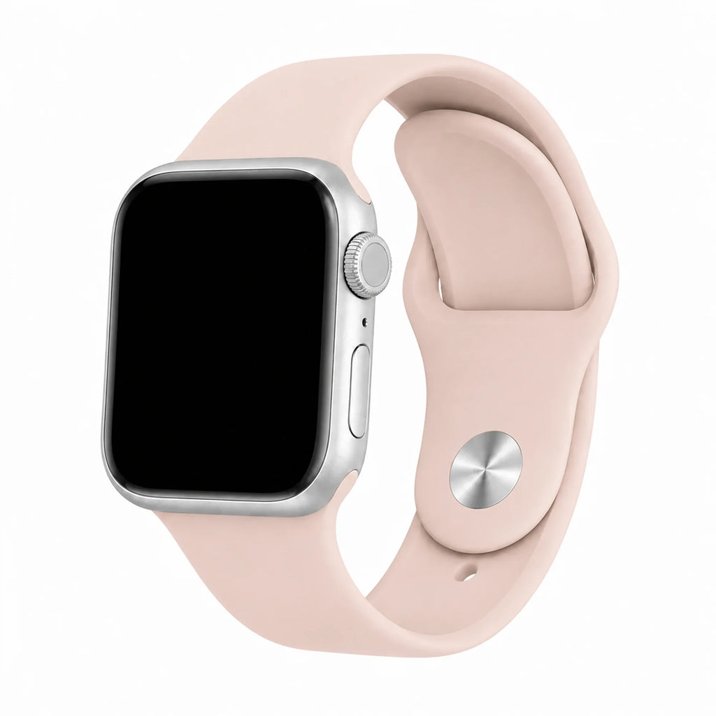 Blush pink silicone Apple Watch band with a light silver digital crown on a black-screen watch