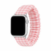 Pink gingham scrunchie Apple Watch band on a pure white background