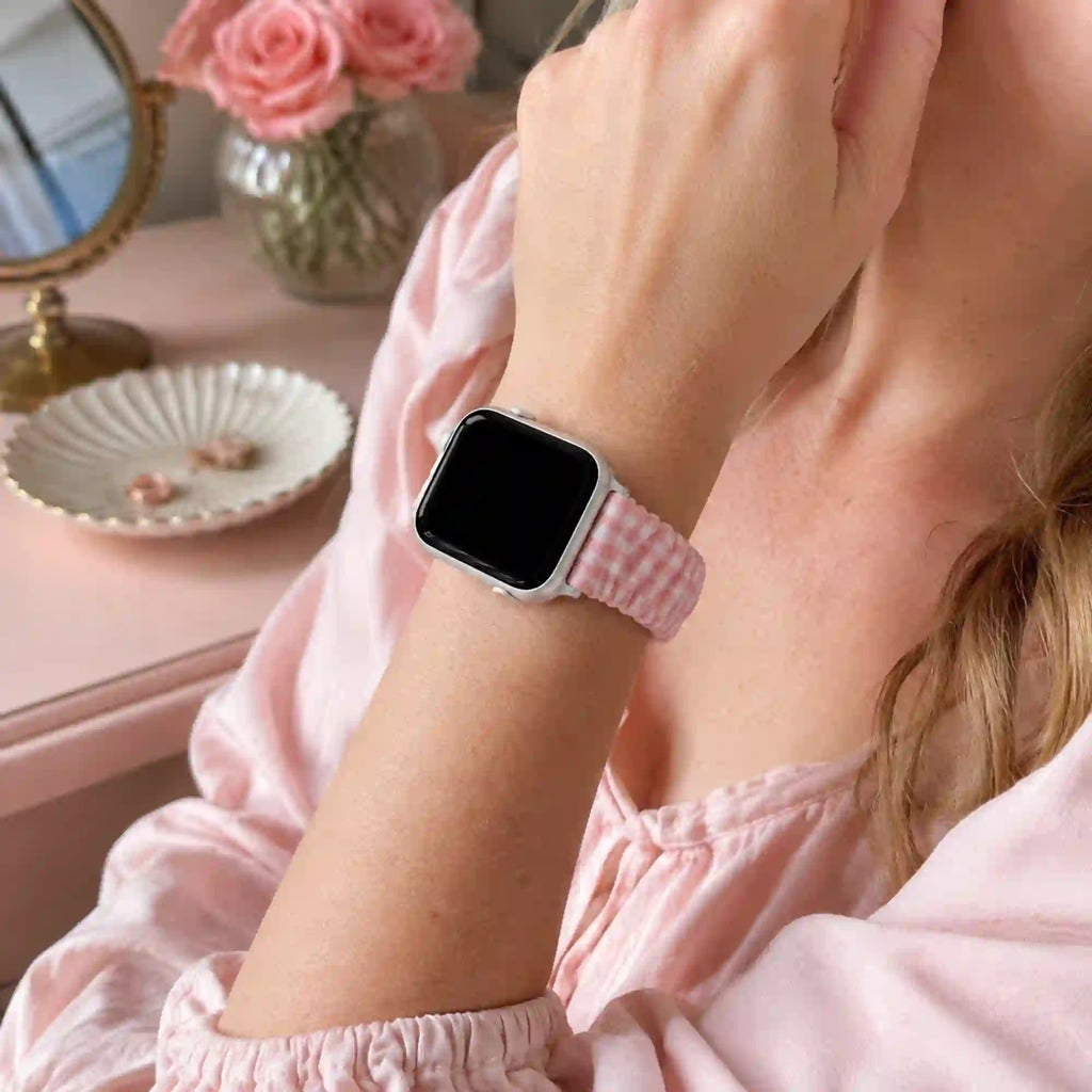 Rosie pink gingham scrunchie Apple Watch band worn with a soft pink cotton blouse.