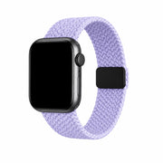 Soline lavender braided loop Apple Watch band with a black watch case on a pure white background.