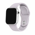 Lavender silicone Apple Watch band with a silver-tone pin closure on a black-screen watch