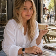 Violette lavender silicone Apple Watch band worn at a relaxed Paris café table.