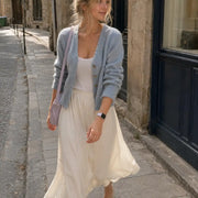 Woman wearing the Violette lavender silicone Apple Watch band with a feminine walking outfit in Paris.