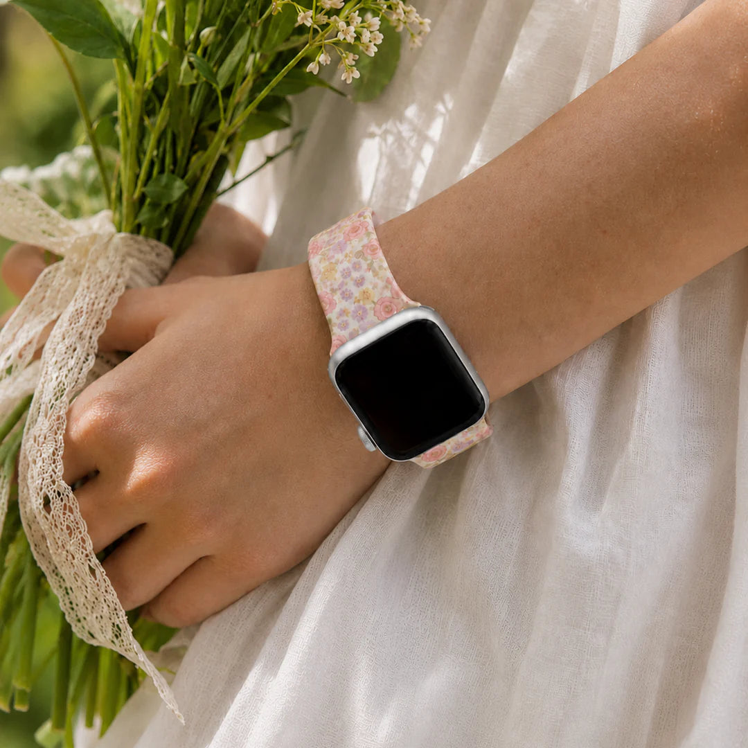 Elodie pink floral Apple Watch band styled with a white dress and wildflowers