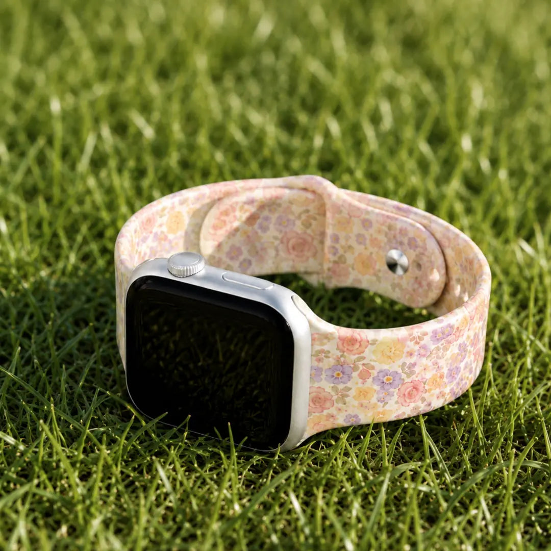 Elodie vintage floral silicone Apple Watch band styled on sunlit grass