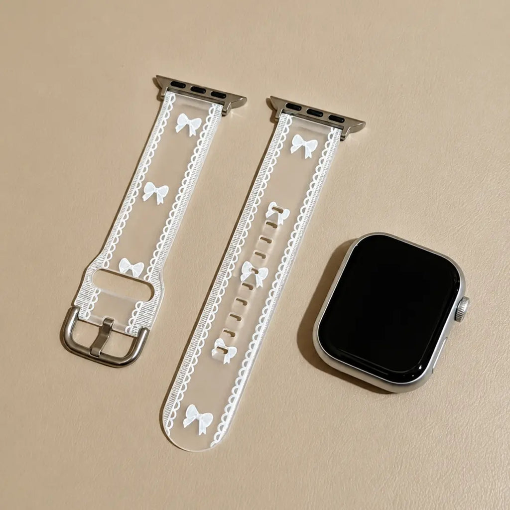 Odette transparent bow lace Apple Watch band flat lay with a silver Apple Watch