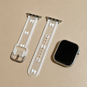 Odette transparent bow lace Apple Watch band flat lay with a silver Apple Watch
