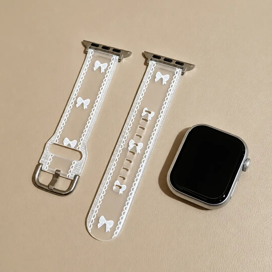 Odette transparent bow lace Apple Watch band flat lay with a silver Apple Watch