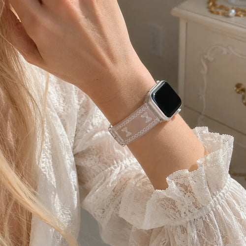 Woman wearing the Odette clear bow lace Apple Watch band with a white lace blouse