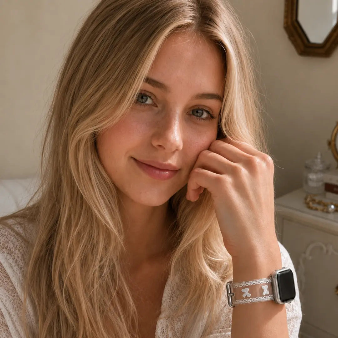 Close-up lifestyle portrait of a woman wearing the Odette clear bow lace TPU Apple Watch band