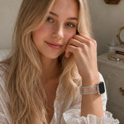 Woman wearing the Odette clear bow lace TPU Apple Watch band with a white lace blouse